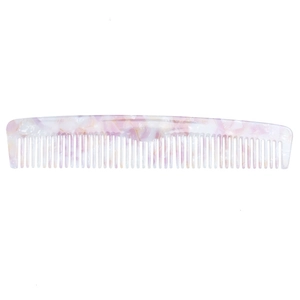 Close-up of translucent marble texture on a pink and white acetate hair comb
