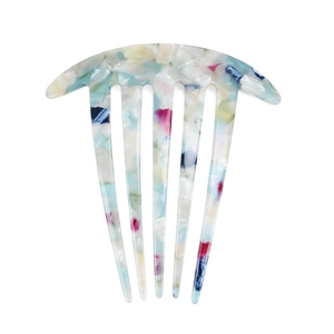 Close-up of colorful acetate hair comb with marble texture and six-tooth design