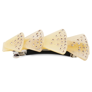 Close-up of cream shell hair clip with sparkling rhinestones and spring clamp