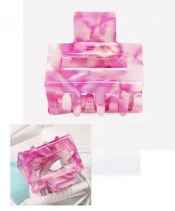 Detailed close-up of a pink marble acetate geometric square hair claw clip with smooth texture