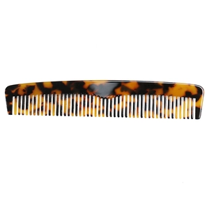 Detailed view of the tortoiseshell pattern hair comb with polished acetate finish