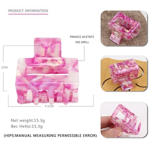 Detail of pink marble acetate hair claw with 5cm size dimensions and hollow design