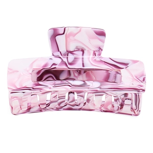 Macro detail of a large marble patterned rectangle hair claw clip in pink and white