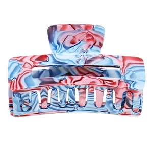 Detailed view of the square hollow hair claw with pink and blue marble acetate pattern
