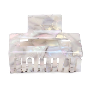 Detail view of square marble texture acetate hair claw clip with iridescent white finish