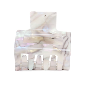 Detailed close-up of white acetate square hair claw clip with marble texture
