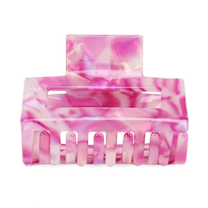 Detail shot of the pink marble textured acetate square hair claw clip with smooth edges