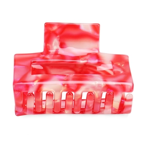 Detailed view of large square hair claw clip with red and cream marbled acetate texture