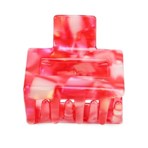 Detail of square acetate claw clip with pink and red marble patterns and gold flakes