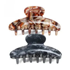 Large acetate hair claws in tortoiseshell and marble patterns with secure grip teeth