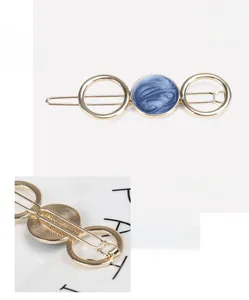 Detail view of gold alloy hair clip with blue marble inlay and size measurements