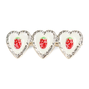Detail of alloy hair clip with white enamel hearts and red strawberry patterns