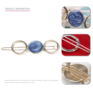Minimalist golden hollow alloy hairpin featuring a blue marble resin circular inlay