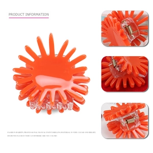 Minimalist sun-shaped orange acetate hair claw clip with glossy finish for women