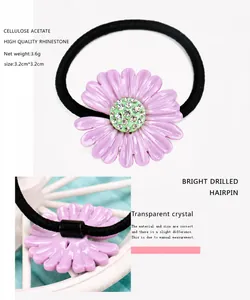 Detail view of purple acetate daisy hair tie with high quality rhinestones and size specs
