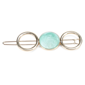 Detail of a gold alloy hair clip featuring three rings with mint green marble texture