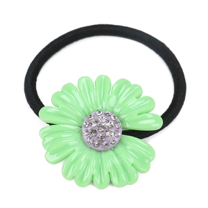 Macro detail of a green acetate daisy hair tie featuring crystal-studded center