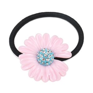 Close-up of pink resin flower hair tie with sparkling rhinestone center and elastic band