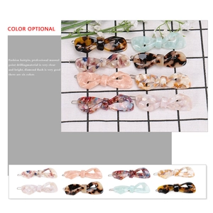 Handmade acetate bow hair clips featuring marble patterns and rhinestones in various colors