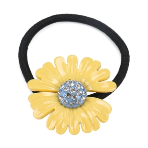 Macro view of daisy hair tie featuring yellow petals and shimmering rhinestone center