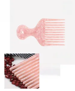 Pink marble acetate hair pick with wide teeth for curly hair styling and volume