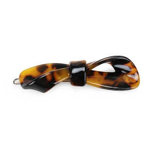 Detail of tortoise shell acetate hair clip with bow design and silver metal clasp