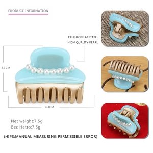 Blue acetate hair claw clip with single row of white pearls and gold-tone teeth
