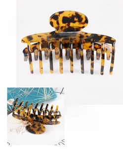 Detail of cellulose acetate hair claw clip showing dimensions 9.8*4.1CM and leopard pattern