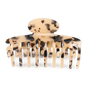 Detailed view of large tortoiseshell hair claw clip with polished finish for thick hair