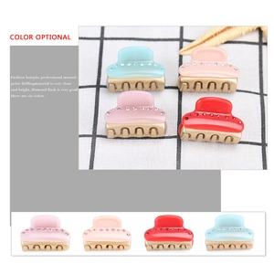 Mini acetate hair claw clips with rhinestones in light blue, pink, and red colors
