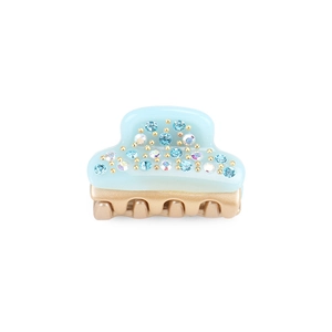 Macro detail of mini acetate hair claw clip with blue crystals and gold-tone teeth