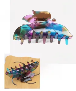 Macro detail of gradient cellulose acetate butterfly hair claw clip with glossy finish