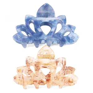 Detail of crown-shaped large acetate hair claws in blue marble and checkered pattern