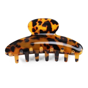 Detail view of large acetate hair claw clip featuring classic leopard tortoise pattern