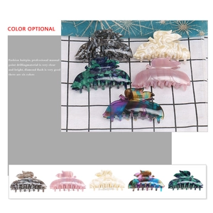 Large acetate hair claw clips in marbled geometric patterns for thick hair styling