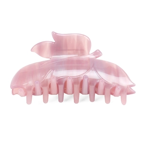 Detail of leaf-shaped pink acetate hair claw clip with marble texture and leaf veins