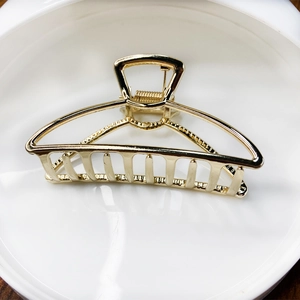 Detailed view of elegant gold alloy hair claw clip with smooth metallic finish