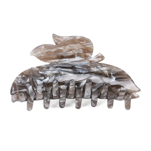 Detail of leaf-shaped hair claw clip with grey marble pattern acetate finish