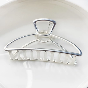 Minimalist silver alloy hollow hair claw clip with metallic finish for elegant women