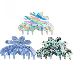 Three acetate hair claws with colorful stripes, blue marble, and checkerboard patterns