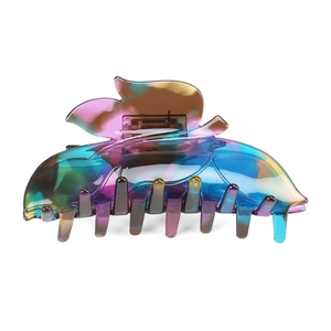 Macro detail of leaf-shaped acetate hair claw with iridescent purple and green gradient