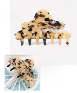 Macro detail of tortoiseshell leopard print hair claw made of premium cellulose acetate