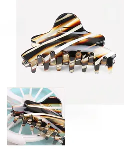 Detail view of cellulose acetate hair claw clip showing 8.9x4.5cm size and 23.3g weight