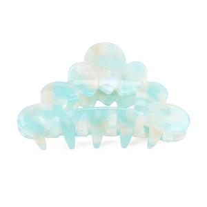 Detail of cloud-shaped hair claw with blue and beige marble acetate texture