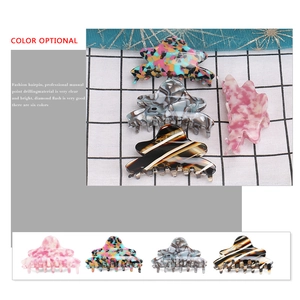 Close-up of assorted colorful acetate hair claws featuring marble and floral patterns