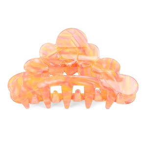 Detailed macro view of acetate hair claw with orange marble texture and strong spring