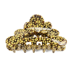 Detail shot of large acetate hair claw clip featuring yellow and brown tortoise shell patterns