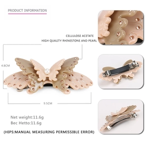 Elegant cellulose acetate butterfly hair clip with champagne rhinestones and pearl detail
