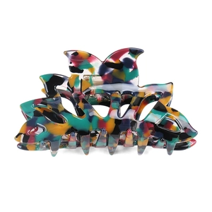Macro shot of colorful acetate hair claw with artistic multicolored floral pattern details