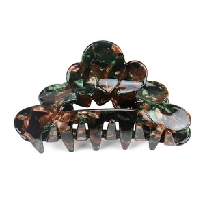 Close-up of tortoise shell pattern on acetate hair claw clip with marble texture detail